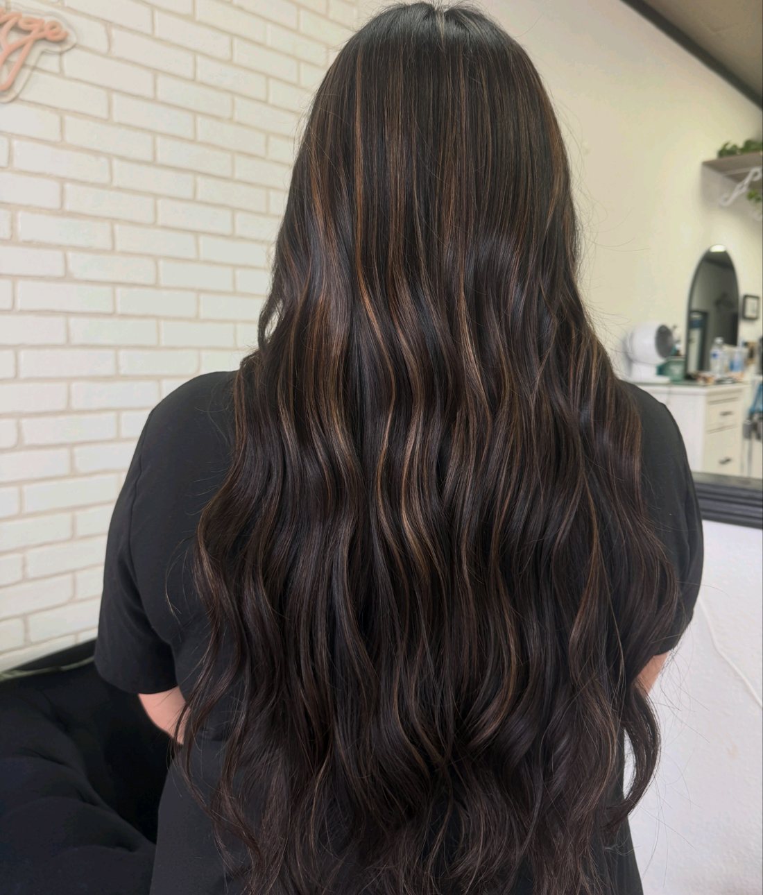 Long dark hair with soft caramel highlights
